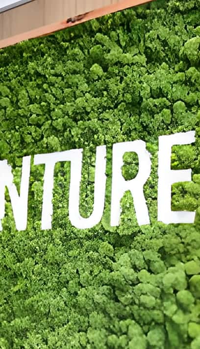 Venture X San Diego sign on greenery background