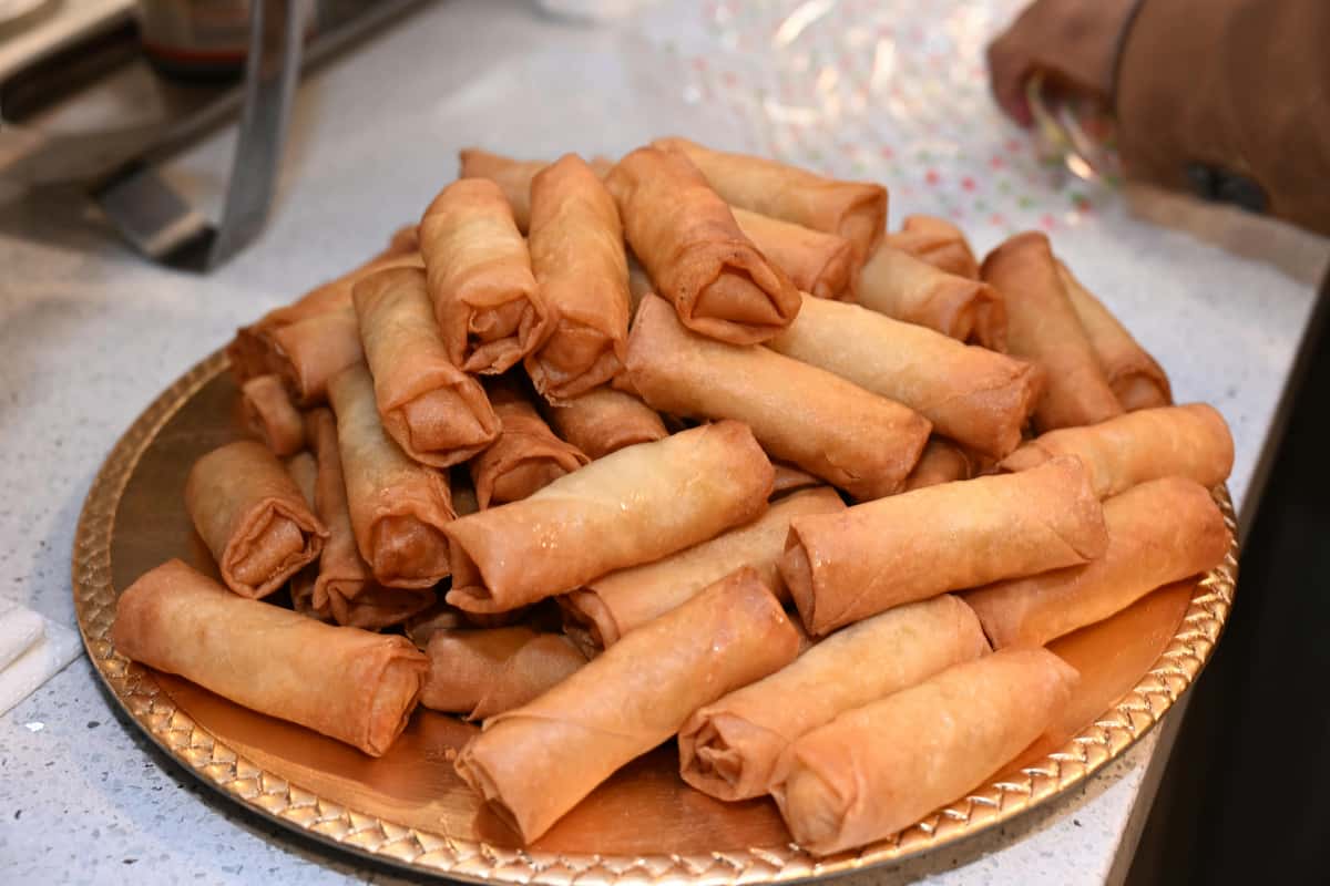 A platter with a stack of fried lumpia
