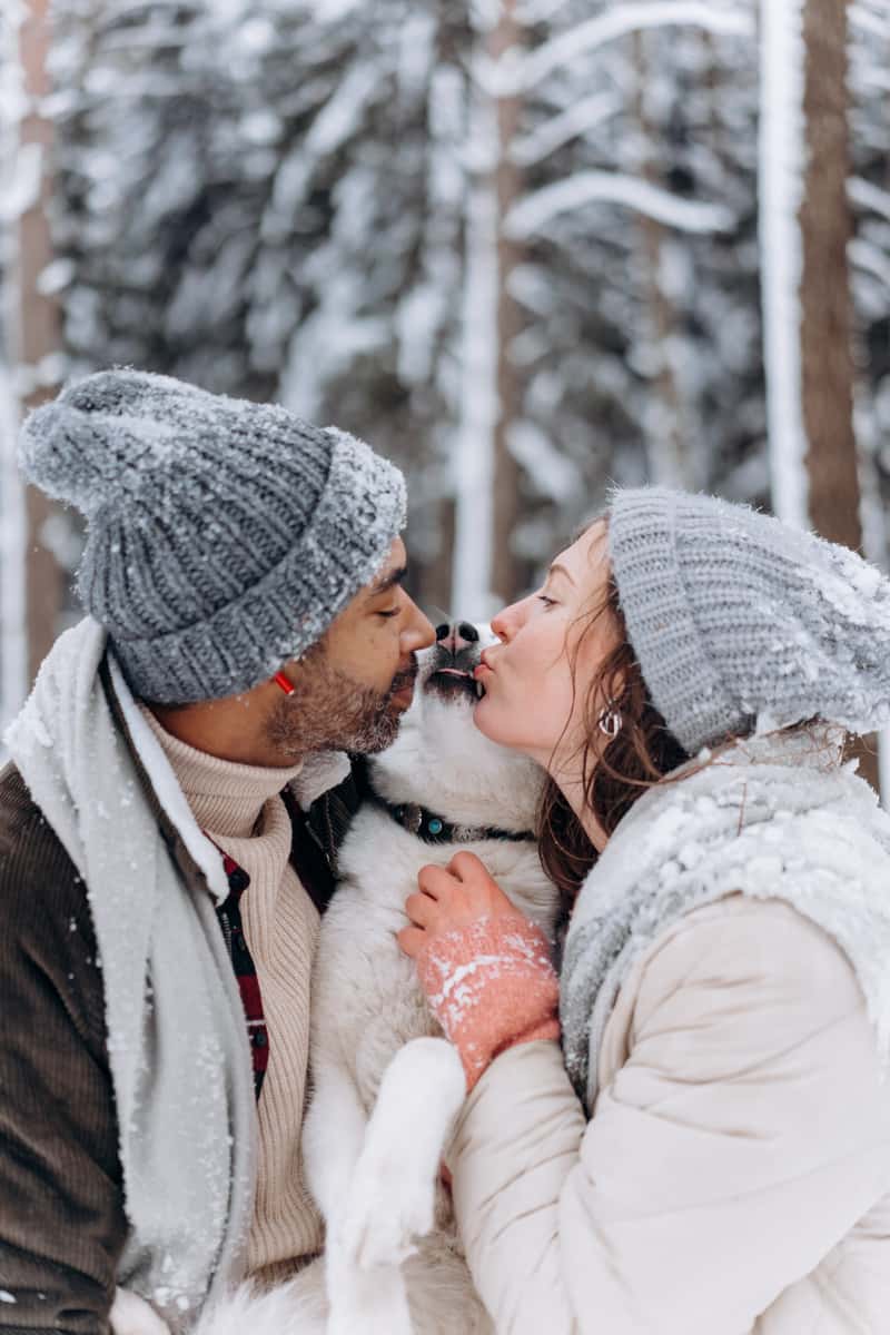 Man and Woman kissing their dog