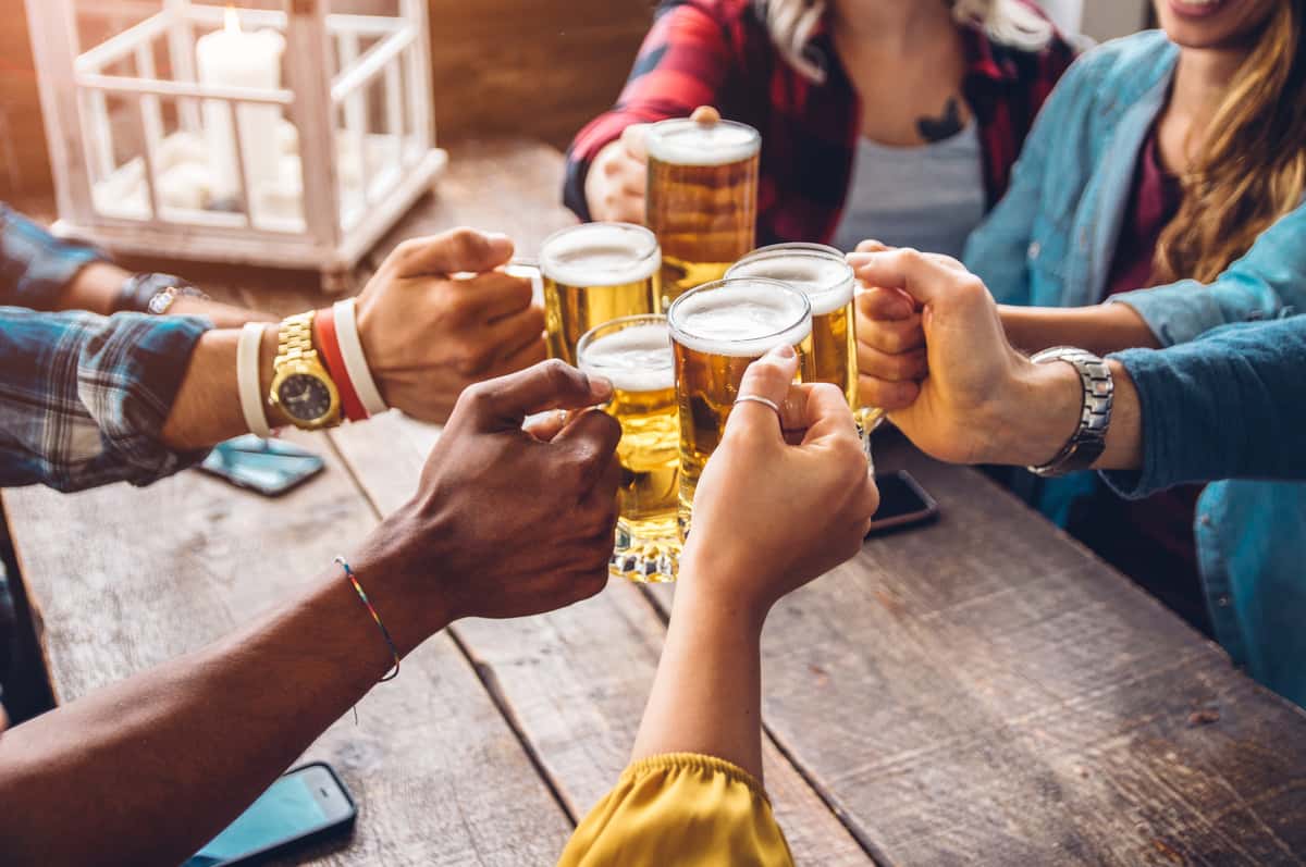 Two people toasting with local craft beer