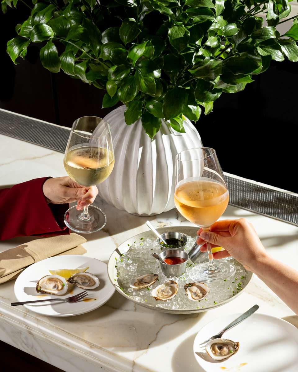 Two people toasting their glasses