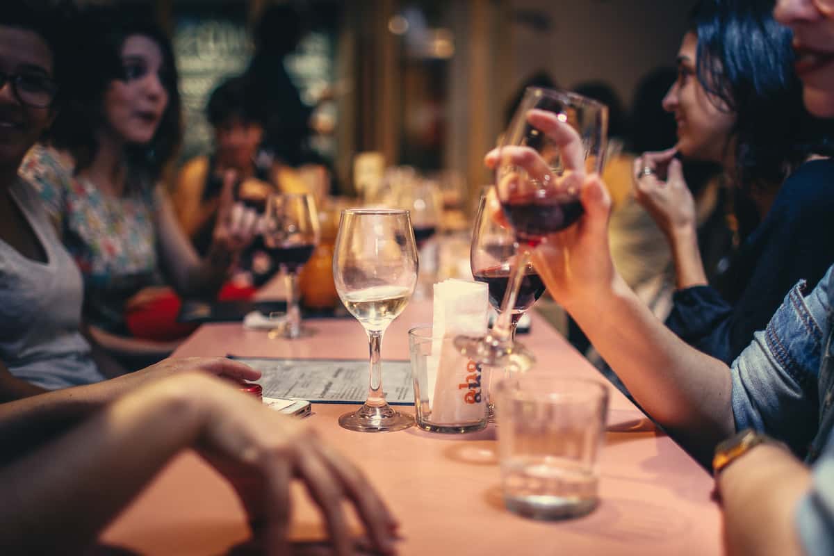 people enjoying wine at the table