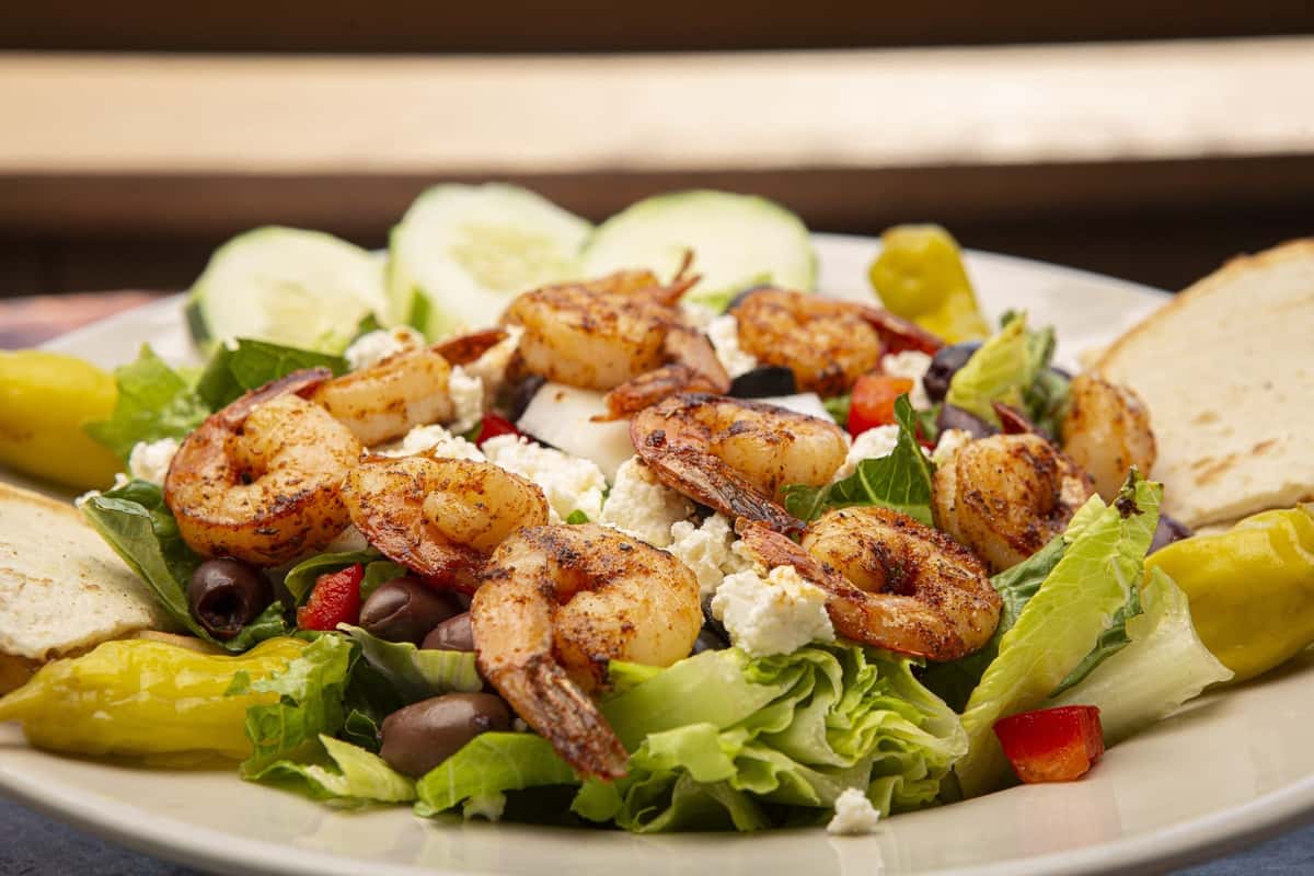 salad topped with grilled shrimp