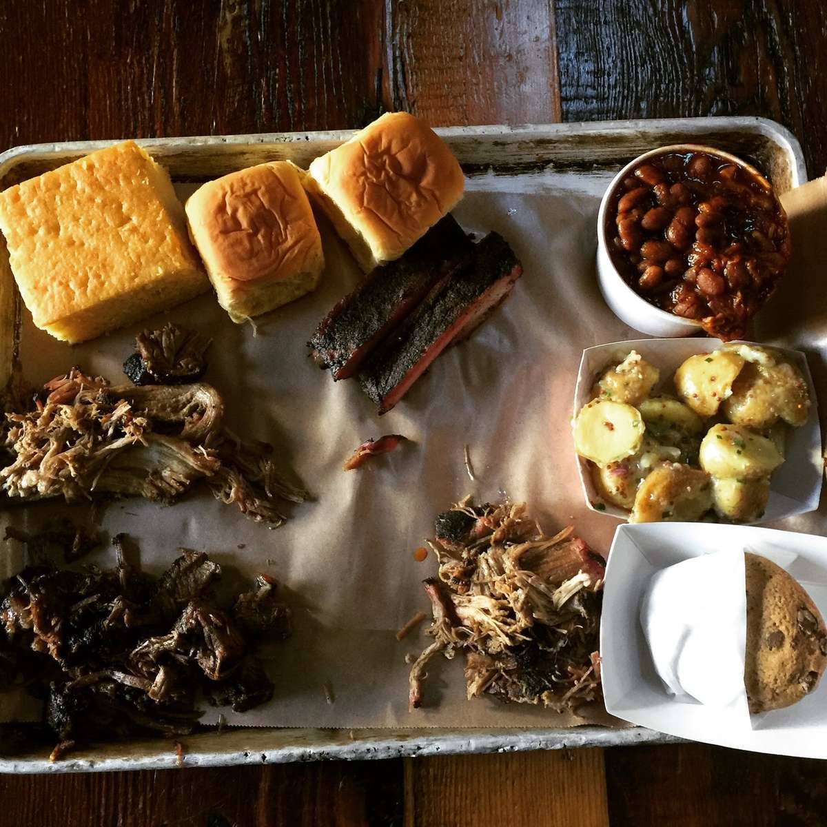 plate of barbecue meats and corn bread
