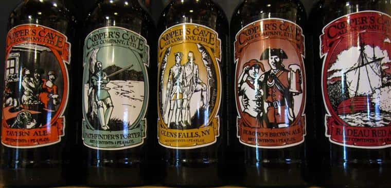bottles of beer with cooper's cave logo on them