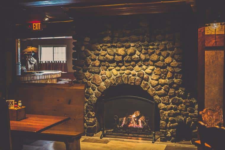 inside restaurant with a booth and fireplace
