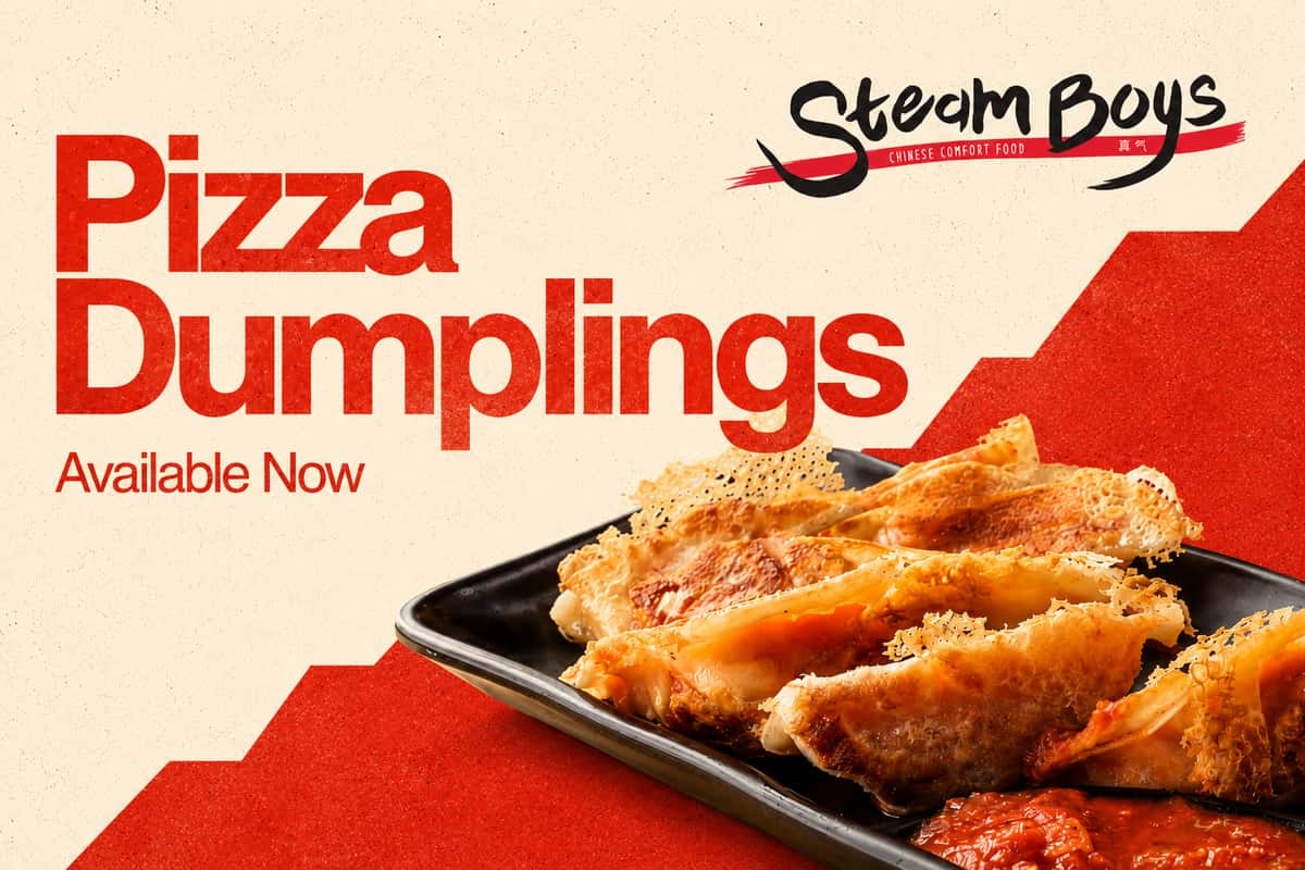Steamboys Pizza Dumplings — crispy pan-fried dumplings served on a black plate with marinara dipping sauce, available now at Steamboys Chinese Comfort Food.