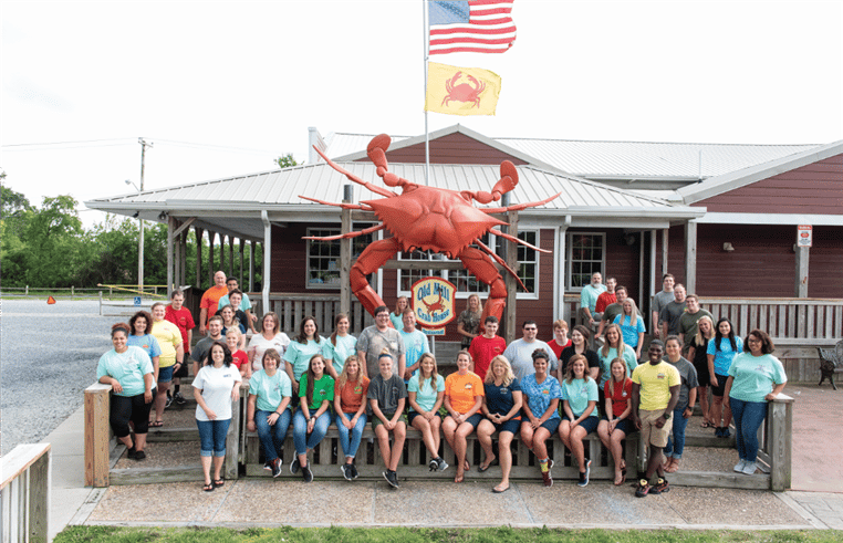 Old Mill Crab House Staff posing for a picture in front of the business