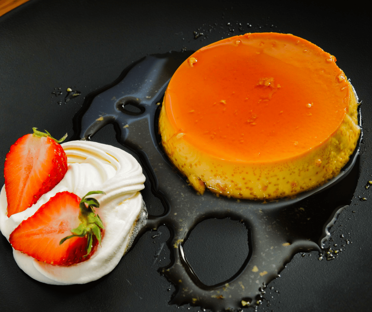 Flan and strawberries on whipped cream