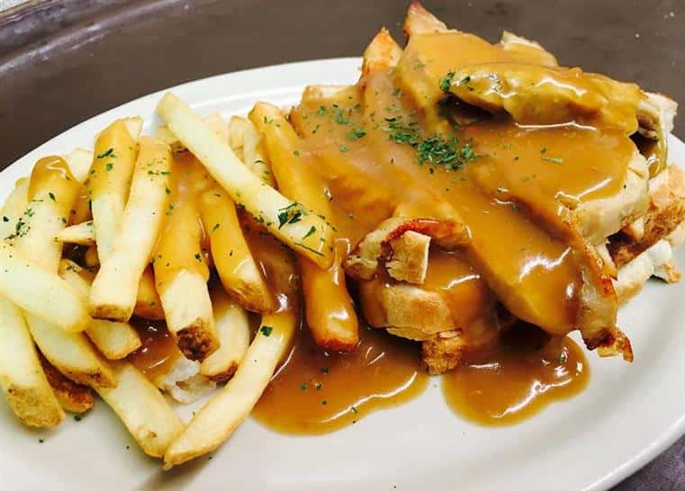 sliced meat with gravy and fries