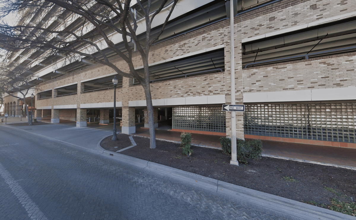 Street view of the 146 Navarro Street parking garage entrance in downtown San Antonio.