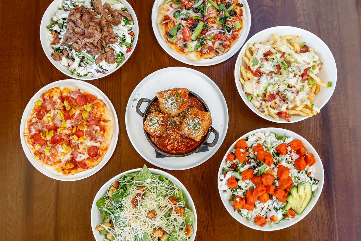 Selection of handcrafted pizzas, salads, burgers and signature dishes from Cook'd