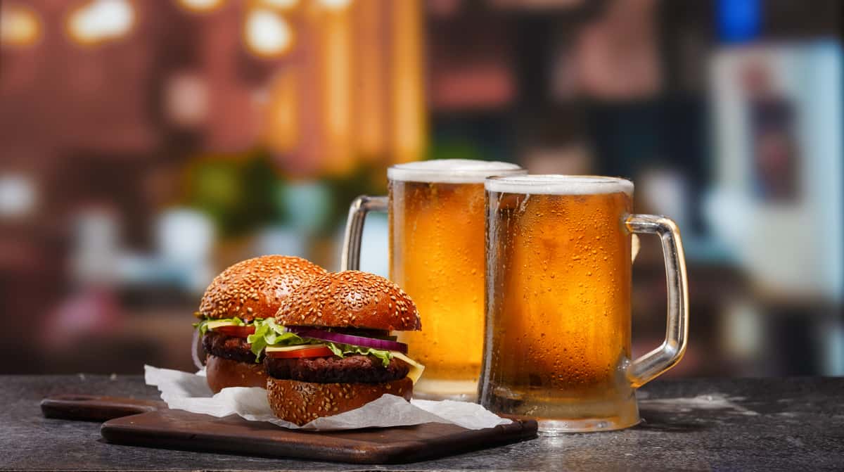 Two beer mugs and two hamburgers