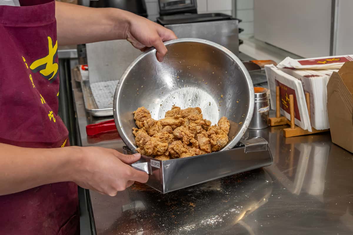 employee serving popcorn chicken