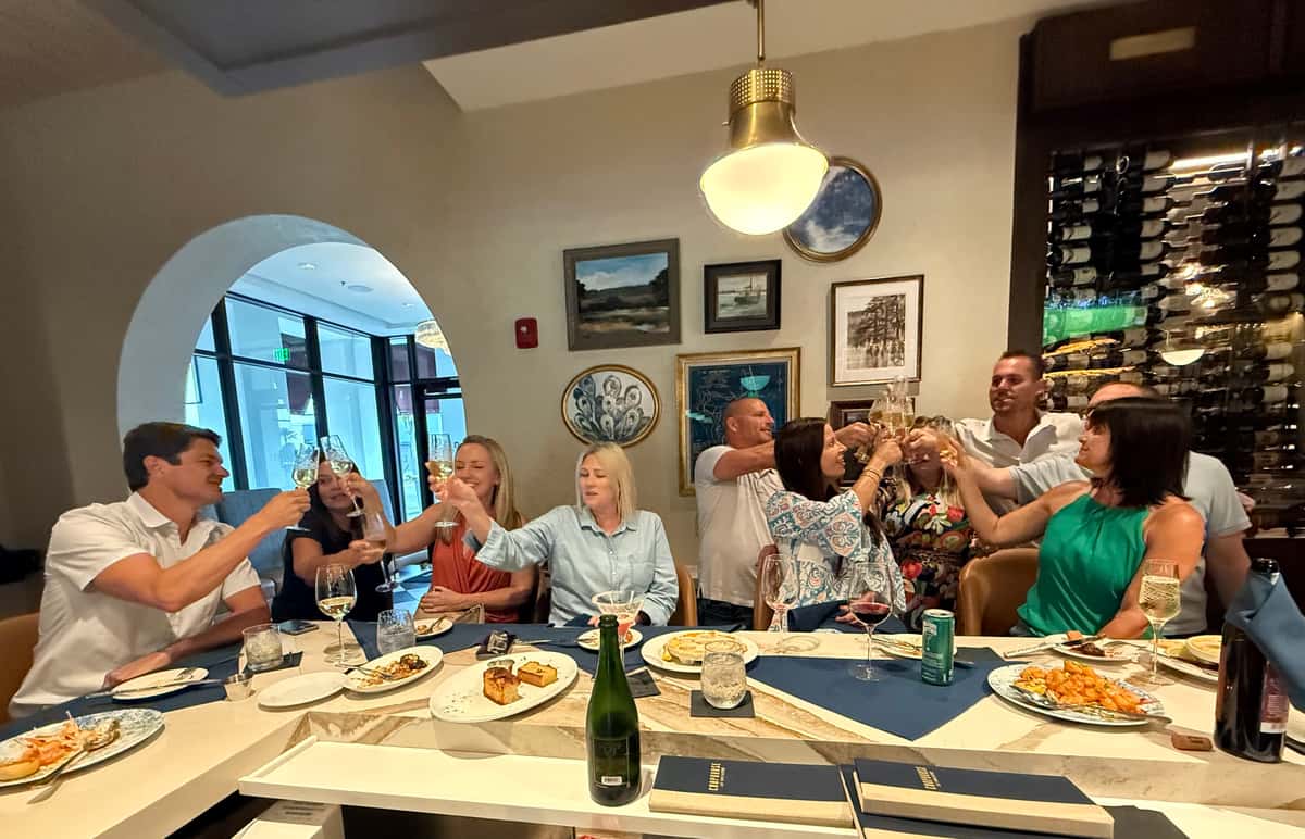 Guests gathered around the bar cheersing at Chophouse at Nocatee