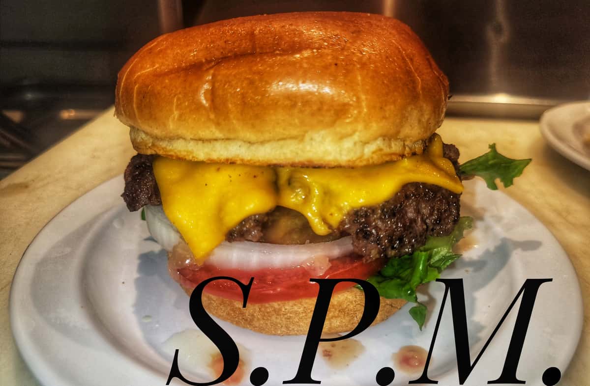 Burger called S.P.M. topped with melted cheese and lettuce
