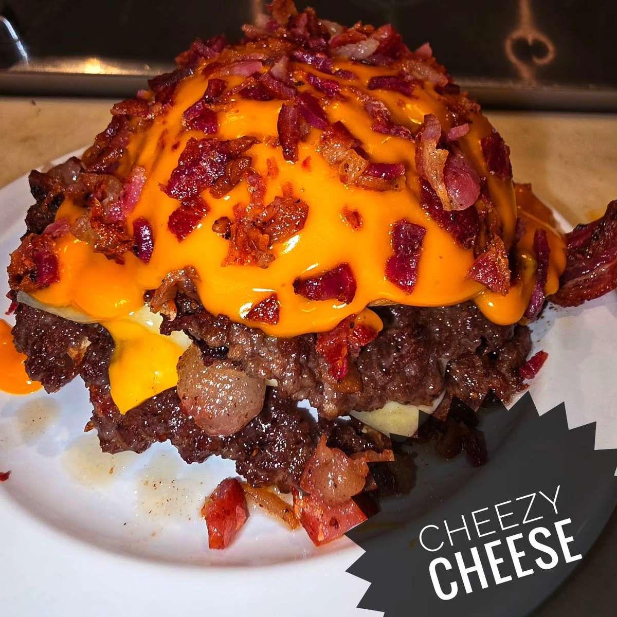 Loaded cheeseburger smothered in cheese sauce and bacon bits