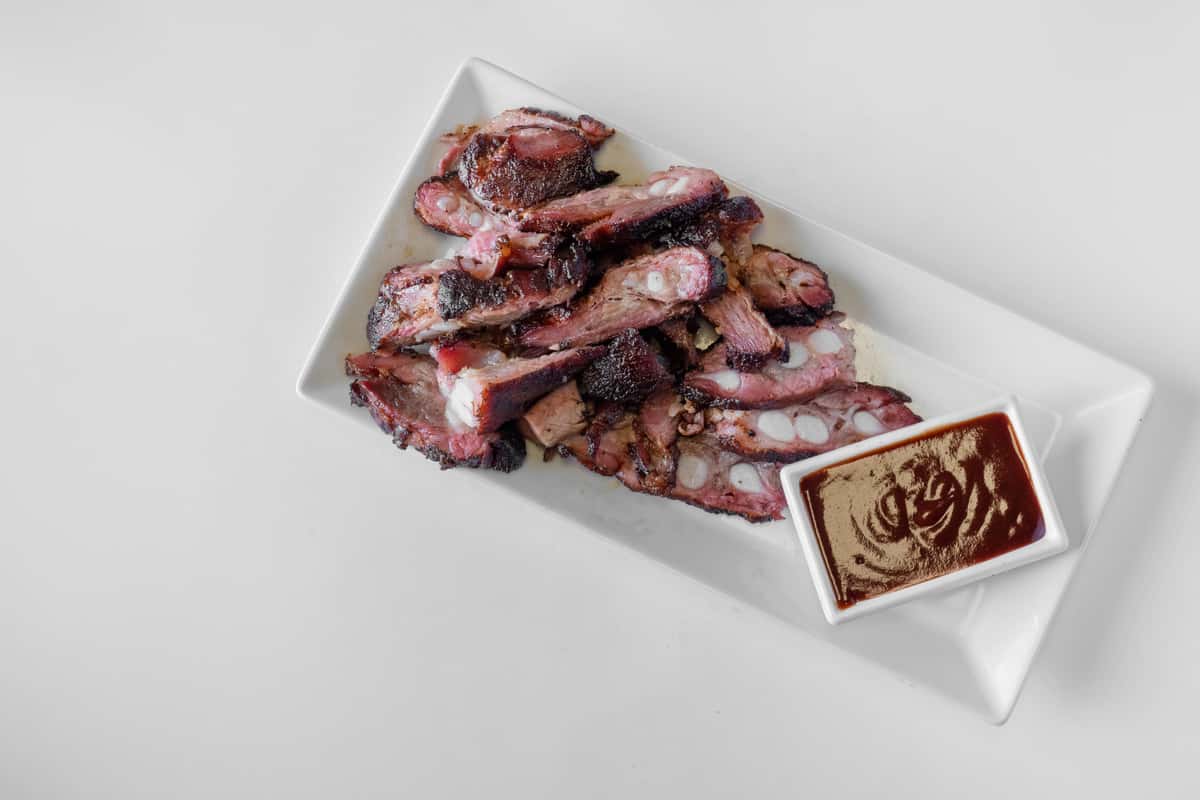 A serving of smoky BBQ rib tips on a white plate