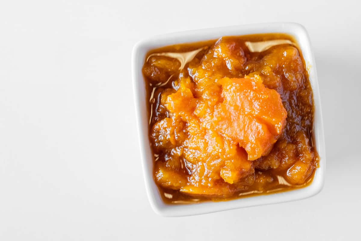 A white bowl filled with creamy sweet potato casserole