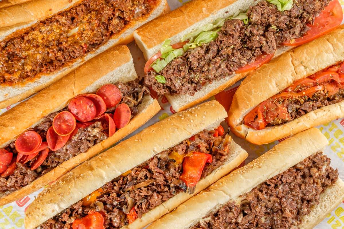 A spread of different philly cheesesteaks