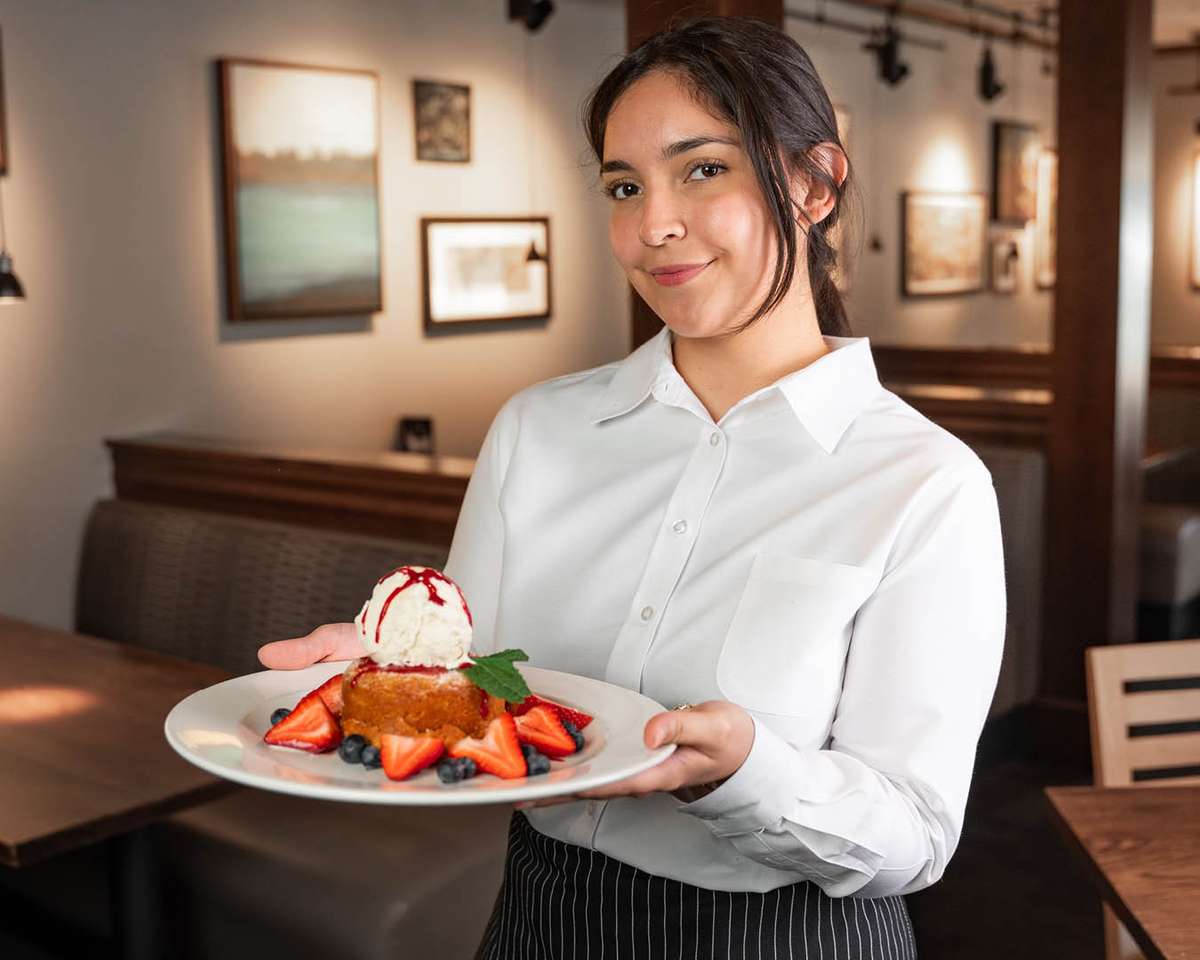 waitress with homemade warm butter cake