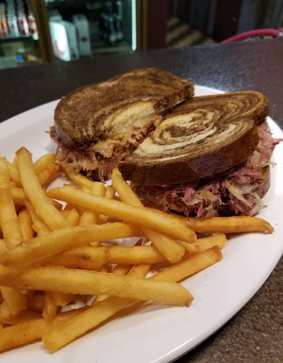 Reuben sandwich on marble rye with French fries