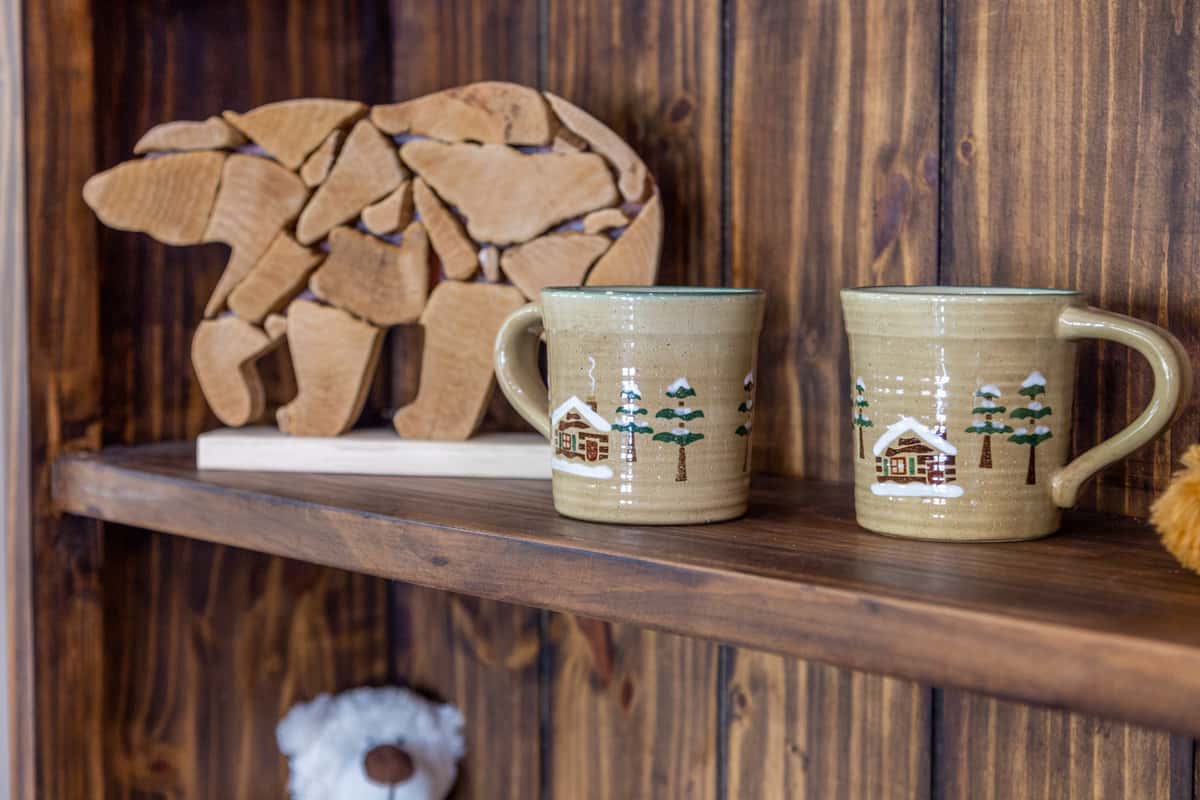 Decorative wooden bear with mugs
