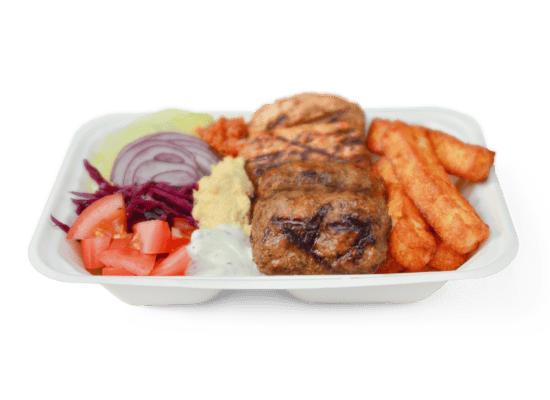 Grilled chicken kebabs served with seasoned rice, hummus, fresh vegetables, and grilled vegetables in a Turkish entrée platter from Ebby's Turkish Kitchen.