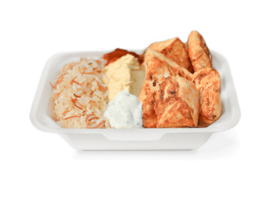 Grilled chicken served with seasoned rice, creamy yogurt sauce, and hummus in a Turkish entrée platter from Ebby's Turkish Kitchen.