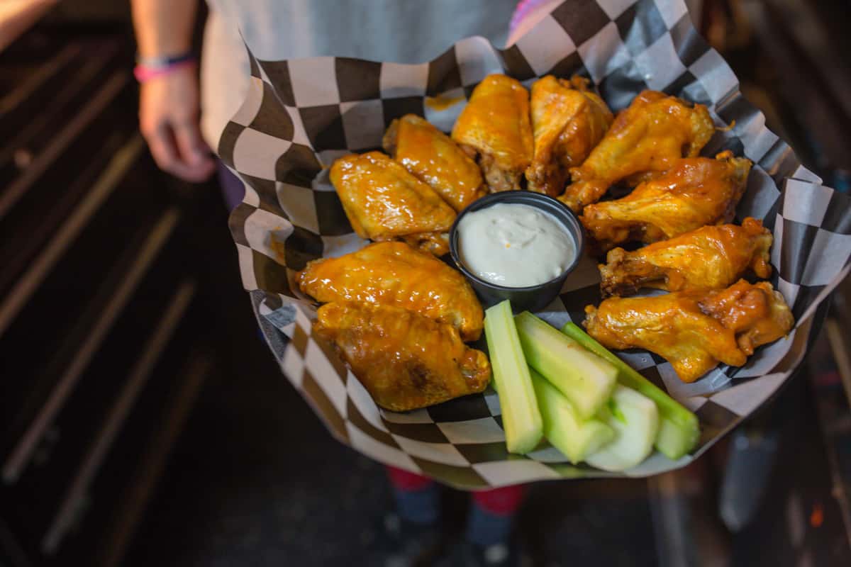 Employee Holding Wings