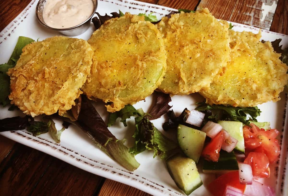 olden-fried Southern-style fish fillets served crispy and hot, paired with fresh diced cucumber salad and house-made pickled vegetables. This comforting plate combines crunchy texture, savory flavor, and classic Southern Porch hospitality in every bite.