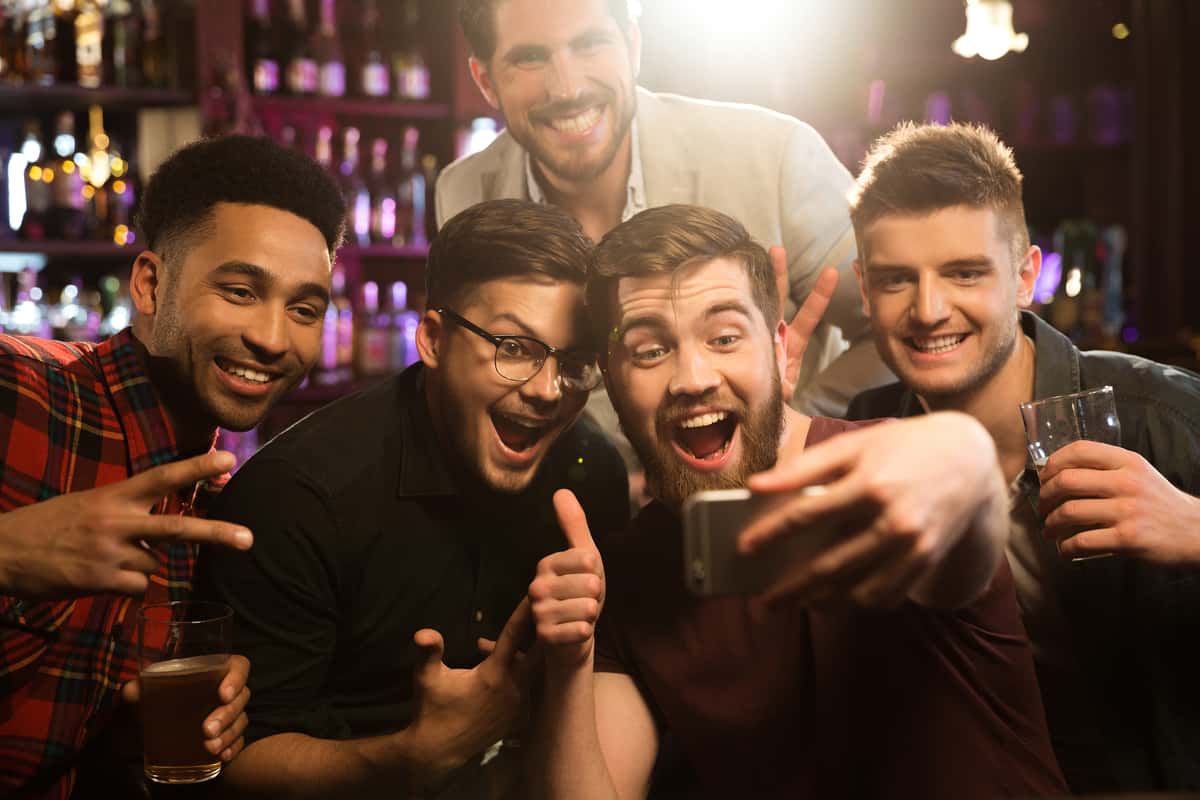 Guys at bar taking selfie