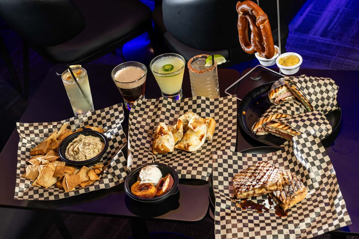 Multiple dishes on checkered paper from The Riot