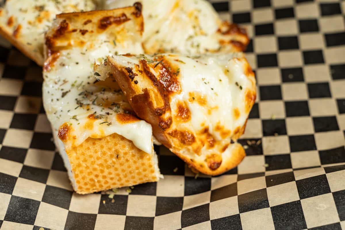 Riot Cheesy Bread on checkered paper