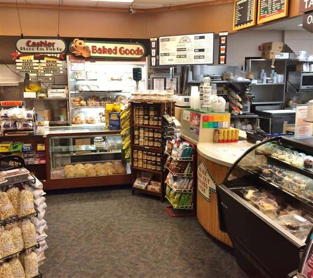 Deli counter, bread cases, food display racks.