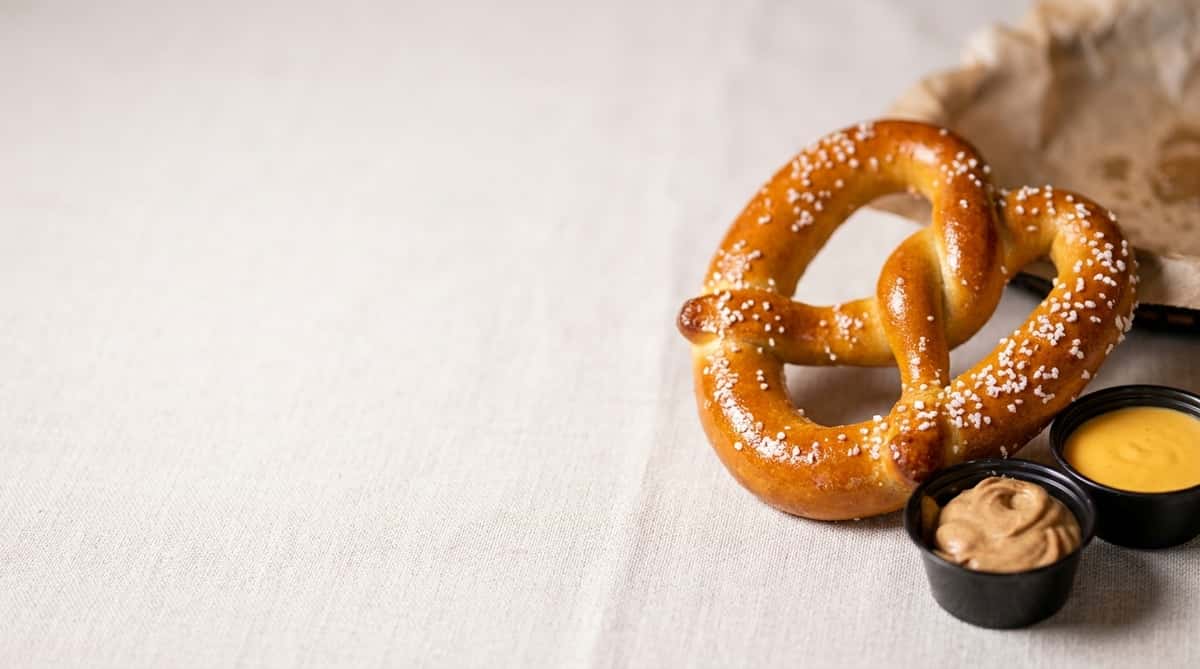 Soft baked pretzel with coarse salt served with mustard and cheese dipping sauces at The Treehouse bar and restaurant in Cleveland.