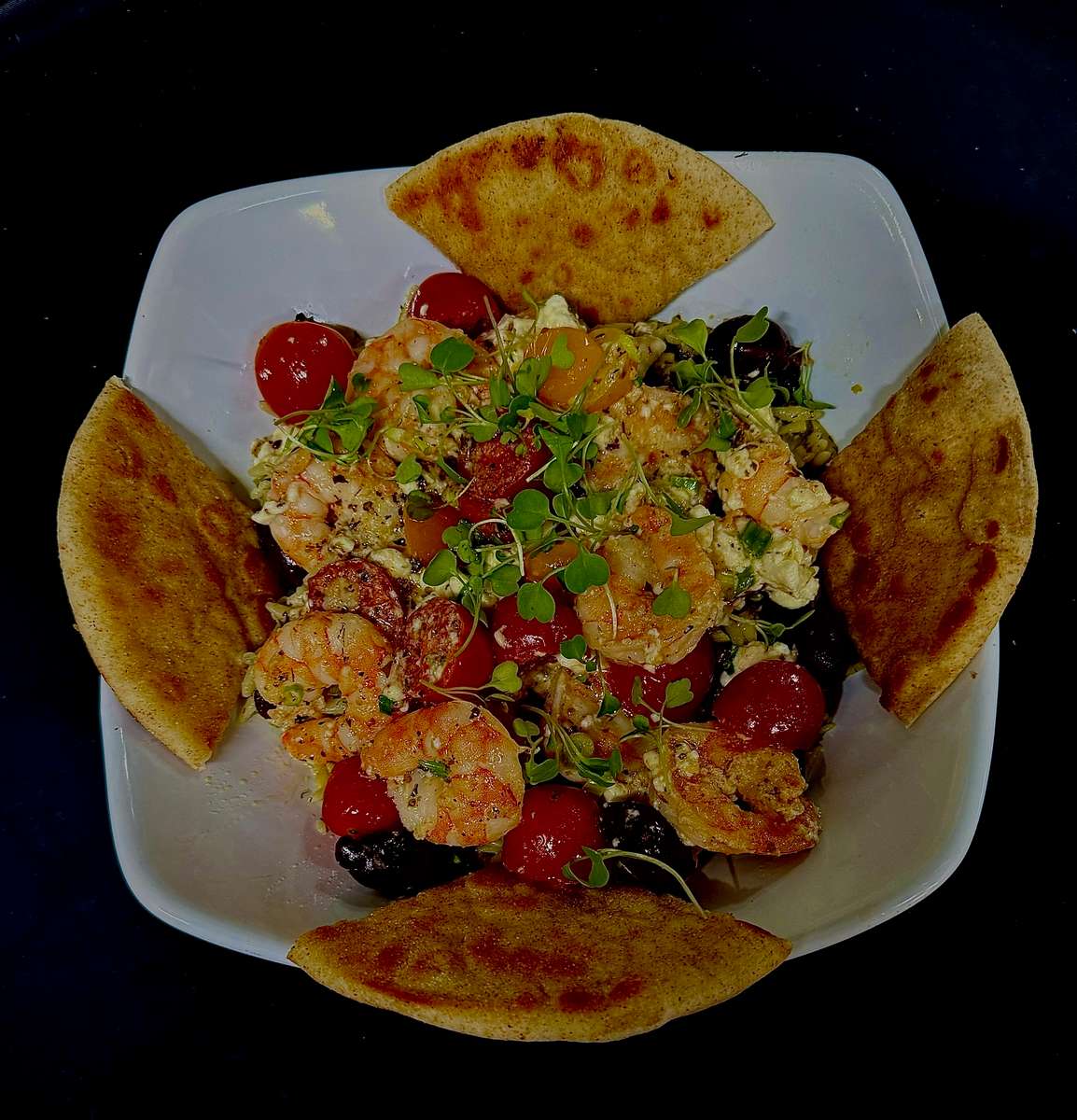 sauteed sweet, tender shrimp in a sherry butter sauce with tomatoes, fresh chives, Greek olives, finished with feta cheese, micro arugula, toasted pita bread
