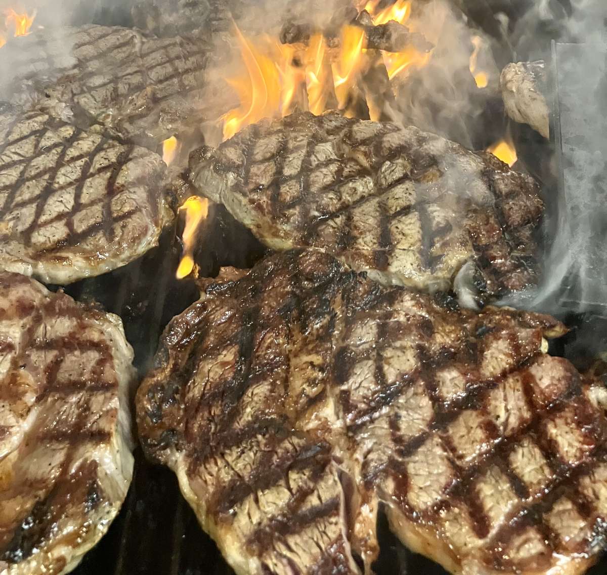 ribeyes on flame broiled grill