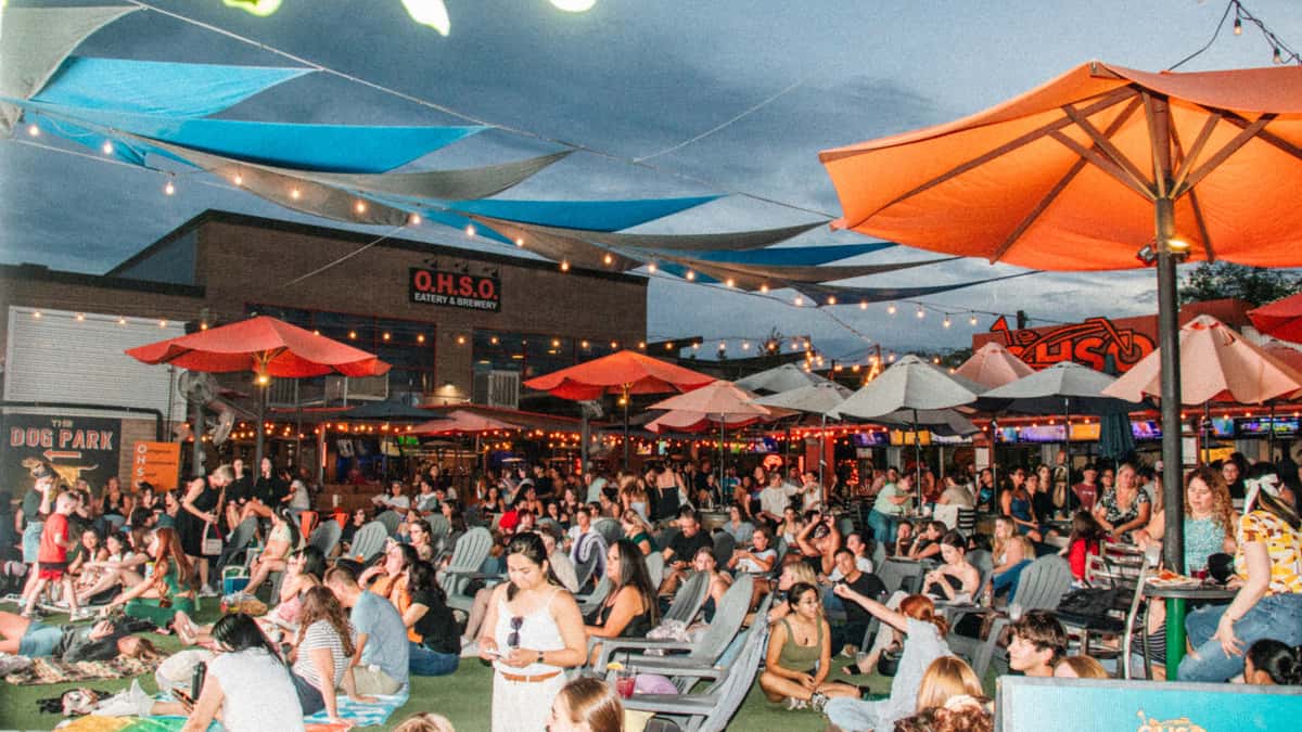 Full crowd at The Park under umbrellas at dusk