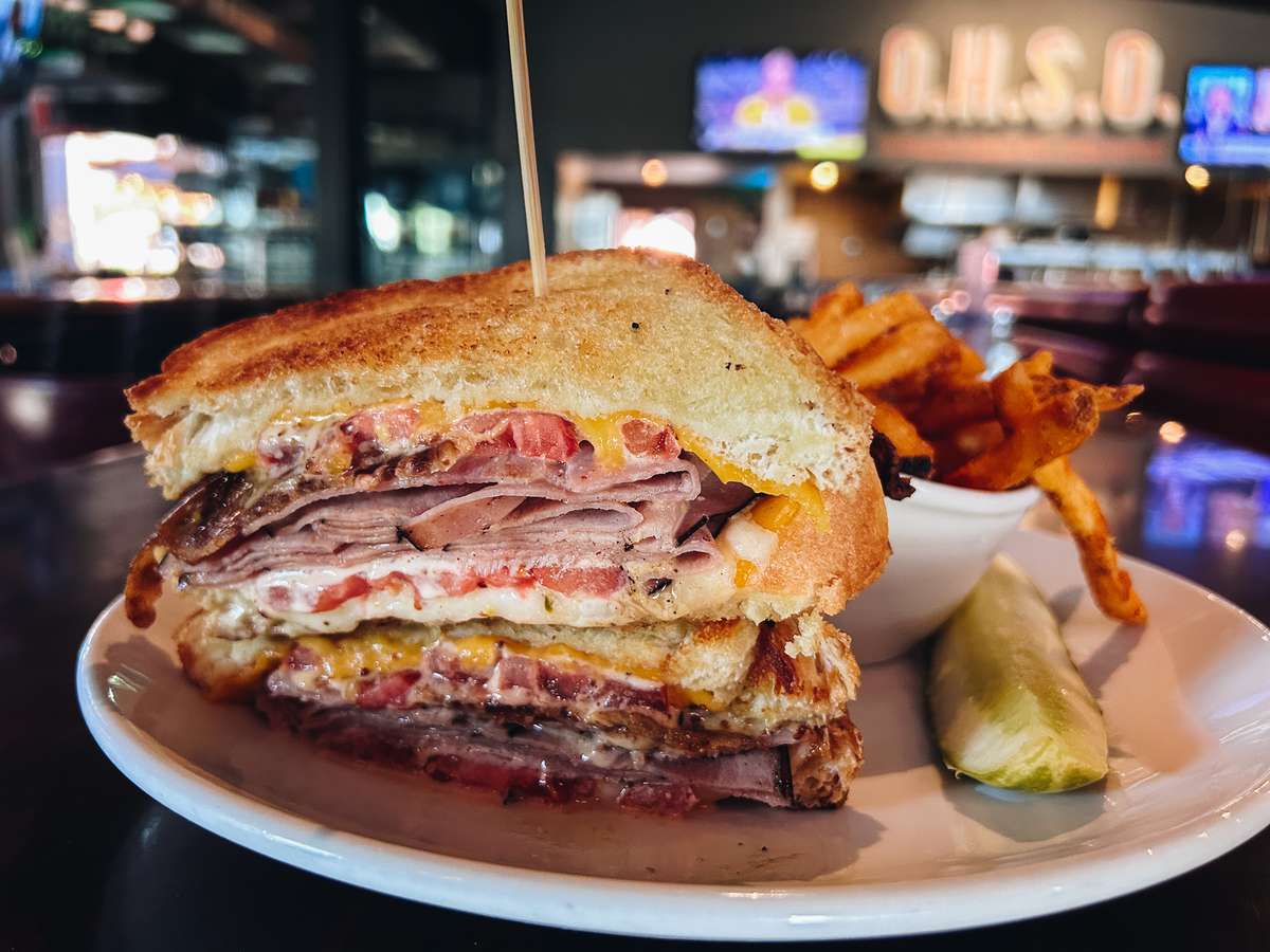The Smokehouse Melt sandwich with ham, bacon, pepper jack and cheddar on Texas toast, served with fries