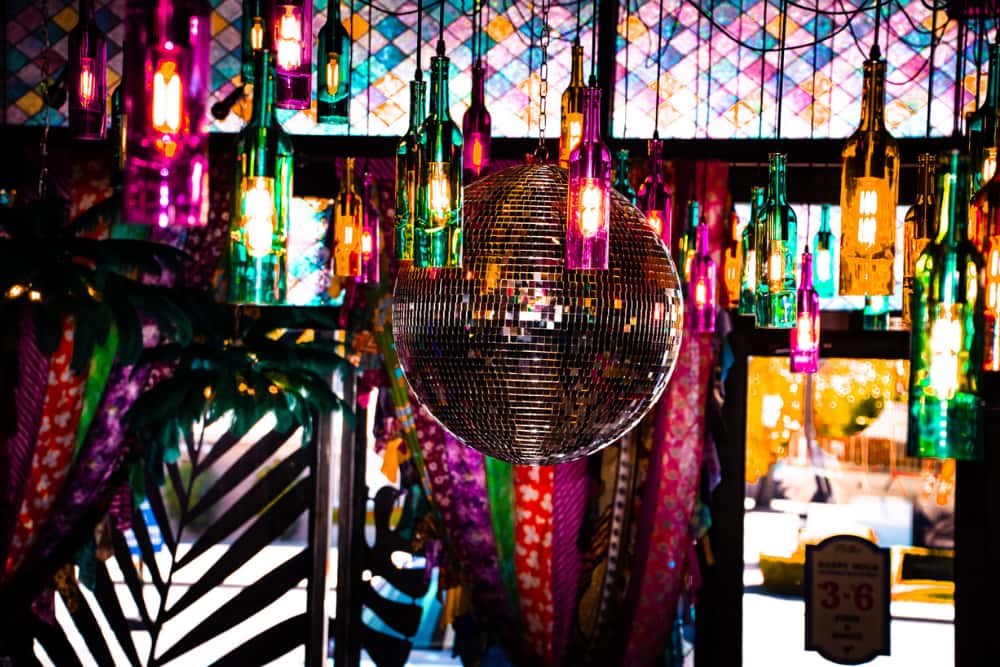 Mirrored disco balls and colorful hanging bottle lights inside O.H.S.O. Party House, a private event venue in Arcadia, Phoenix.