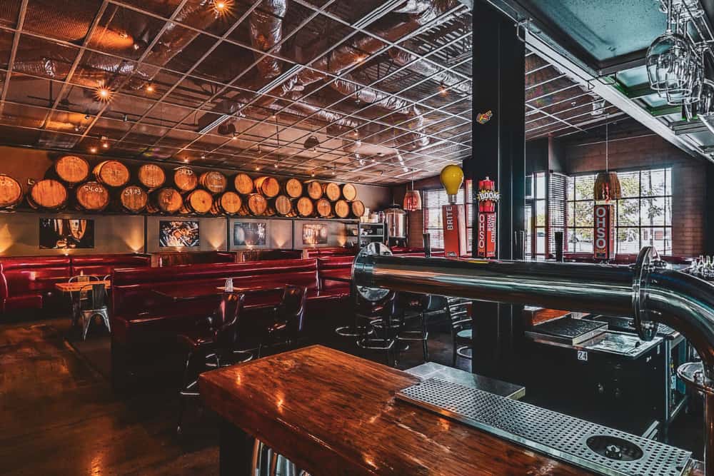 Private Barrel Room at O.H.S.O. Gilbert in Downtown Gilbert, featuring its own bar, indoor seating, and barrel-lined walls for group events.
