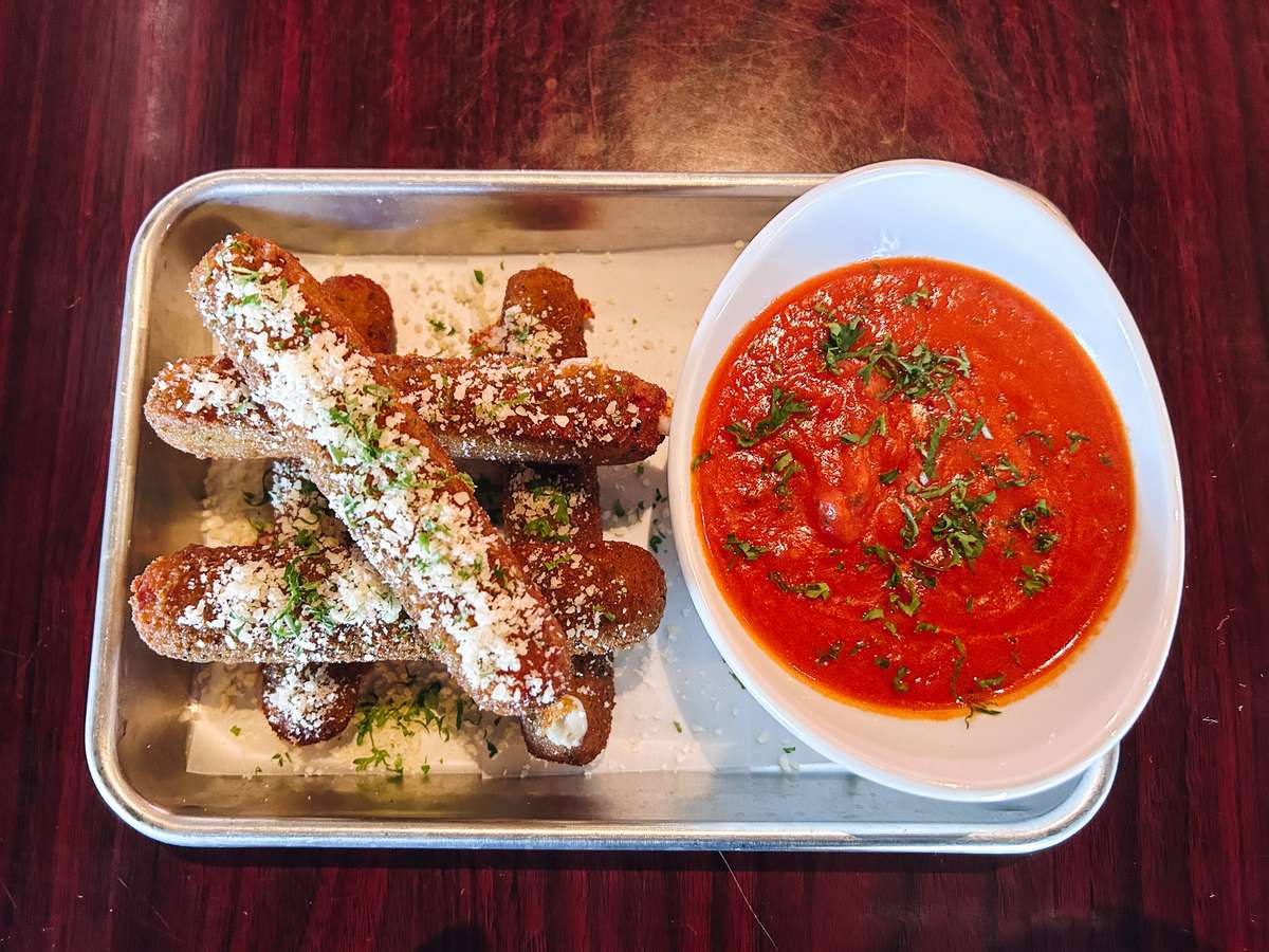 Crispy mozzarella sticks topped with parmesan and parsley, served with spicy vodka sauce