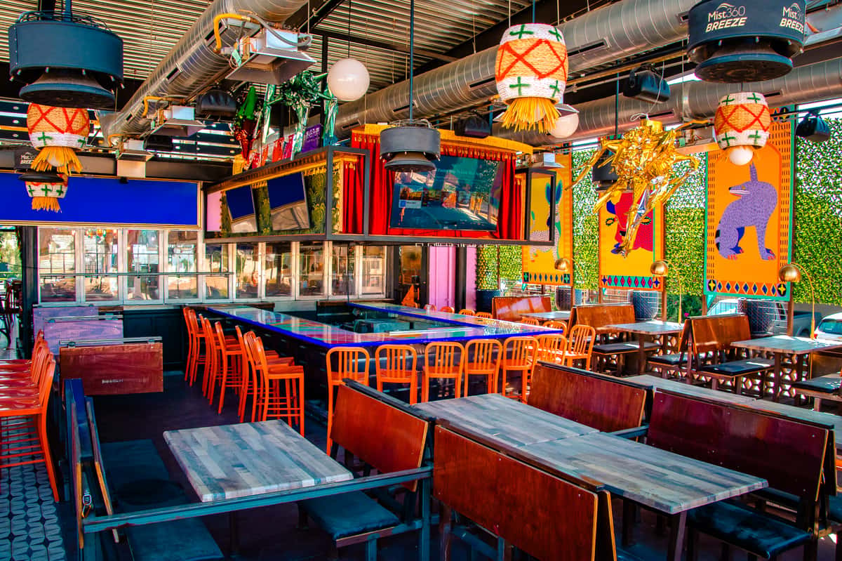 event space at O.H.S.O. Party House in Arcadia, Phoenix, with a full bar, colorful décor, TVs, and flexible seating for private parties.