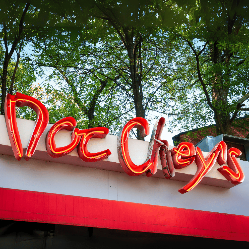 Neon Sign hanging on the front of Doc Chey's building