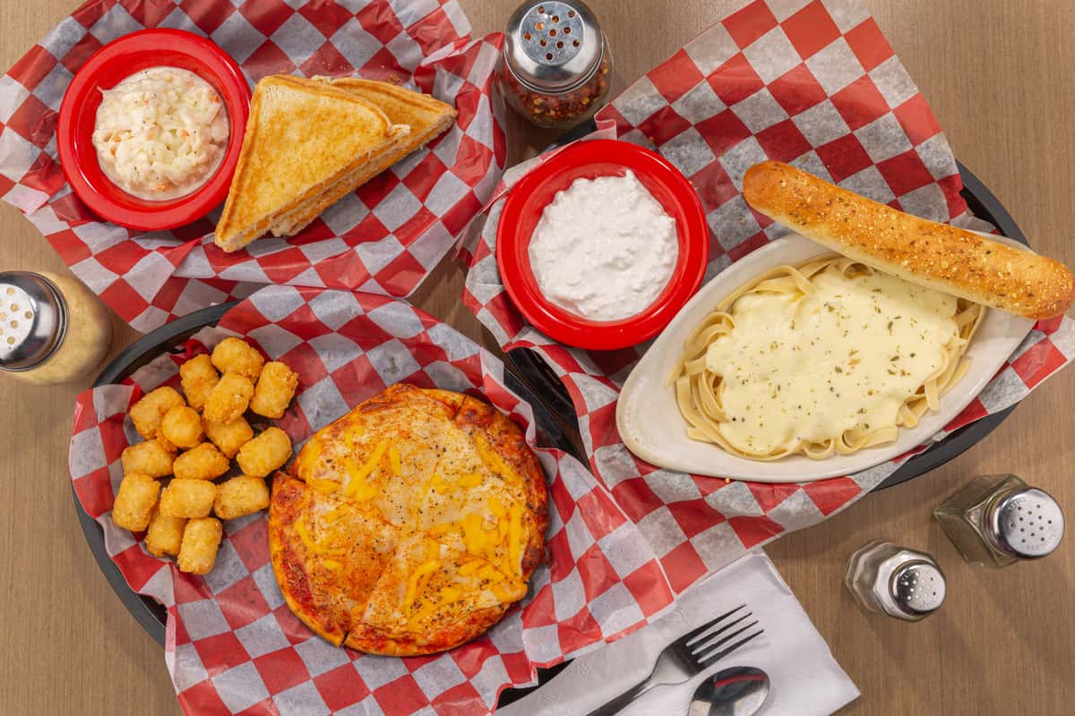 Overhead spread of pizza, breadsticks, dipping sauces, and appetizers at The Gaslight Pizza & Grill in Huntingburg, Indiana