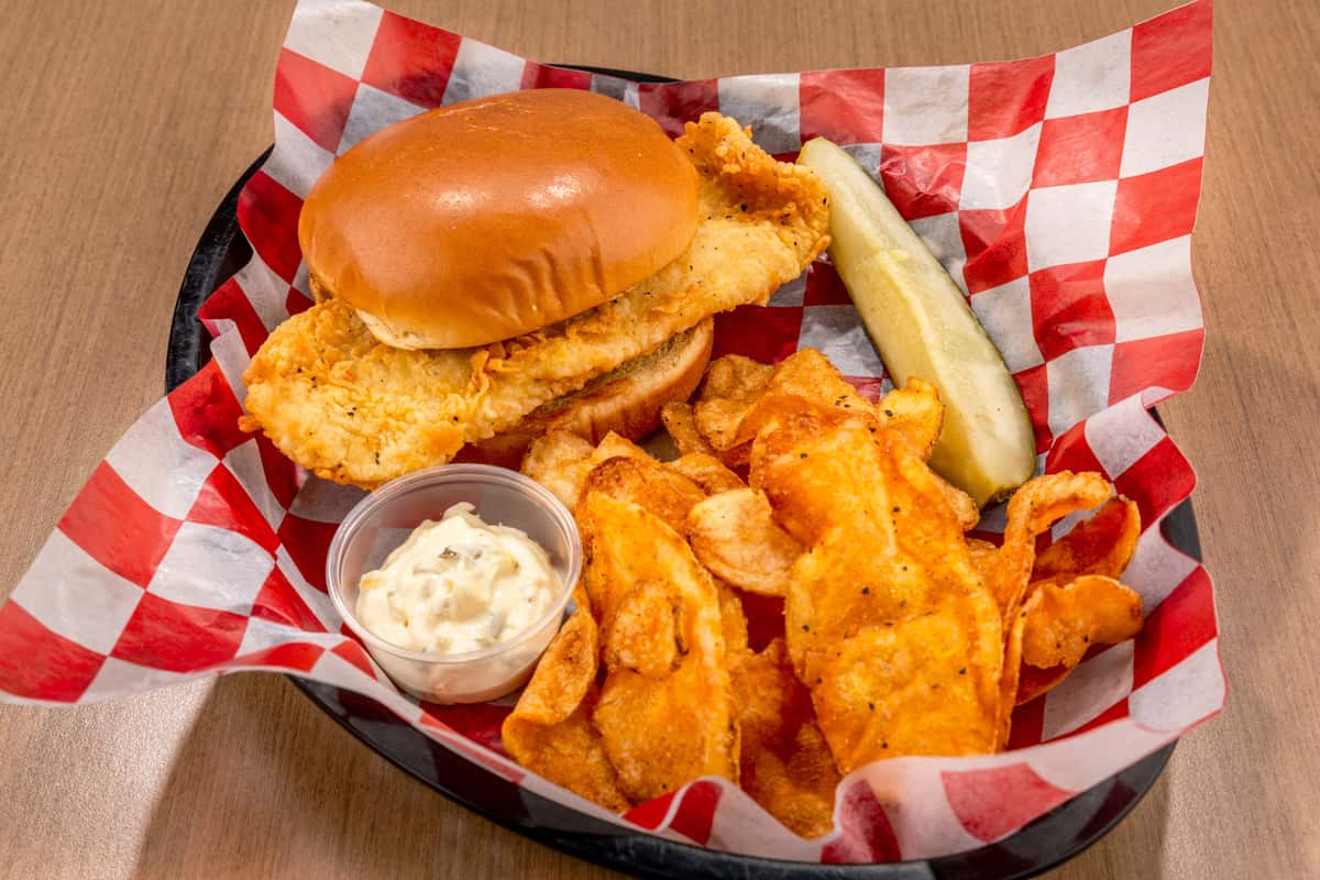 Crispy fish fillet sandwich with tartar sauce and house chips at The Gaslight Pizza & Grill in Huntingburg, Indiana