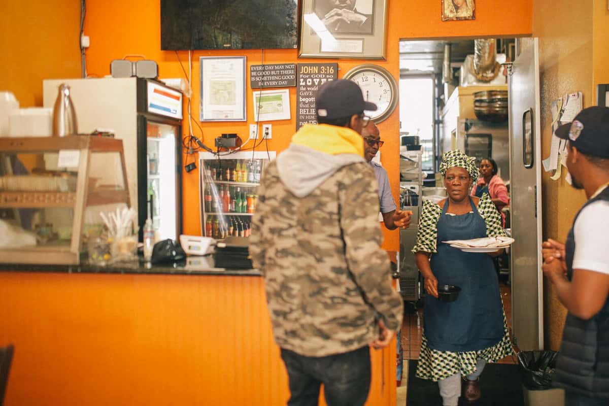 Restaurant owner serving patron