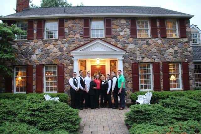 group of people standing in front of a house