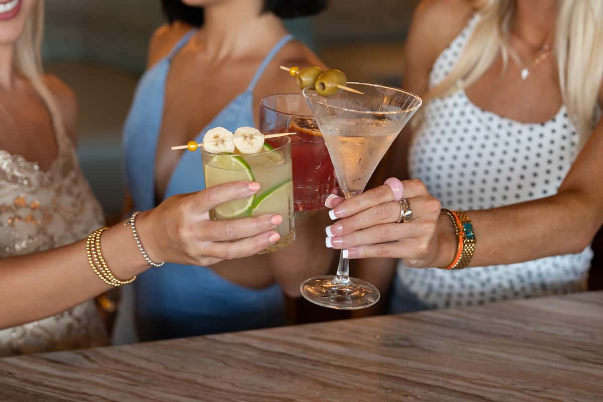Women holding Three cocktails